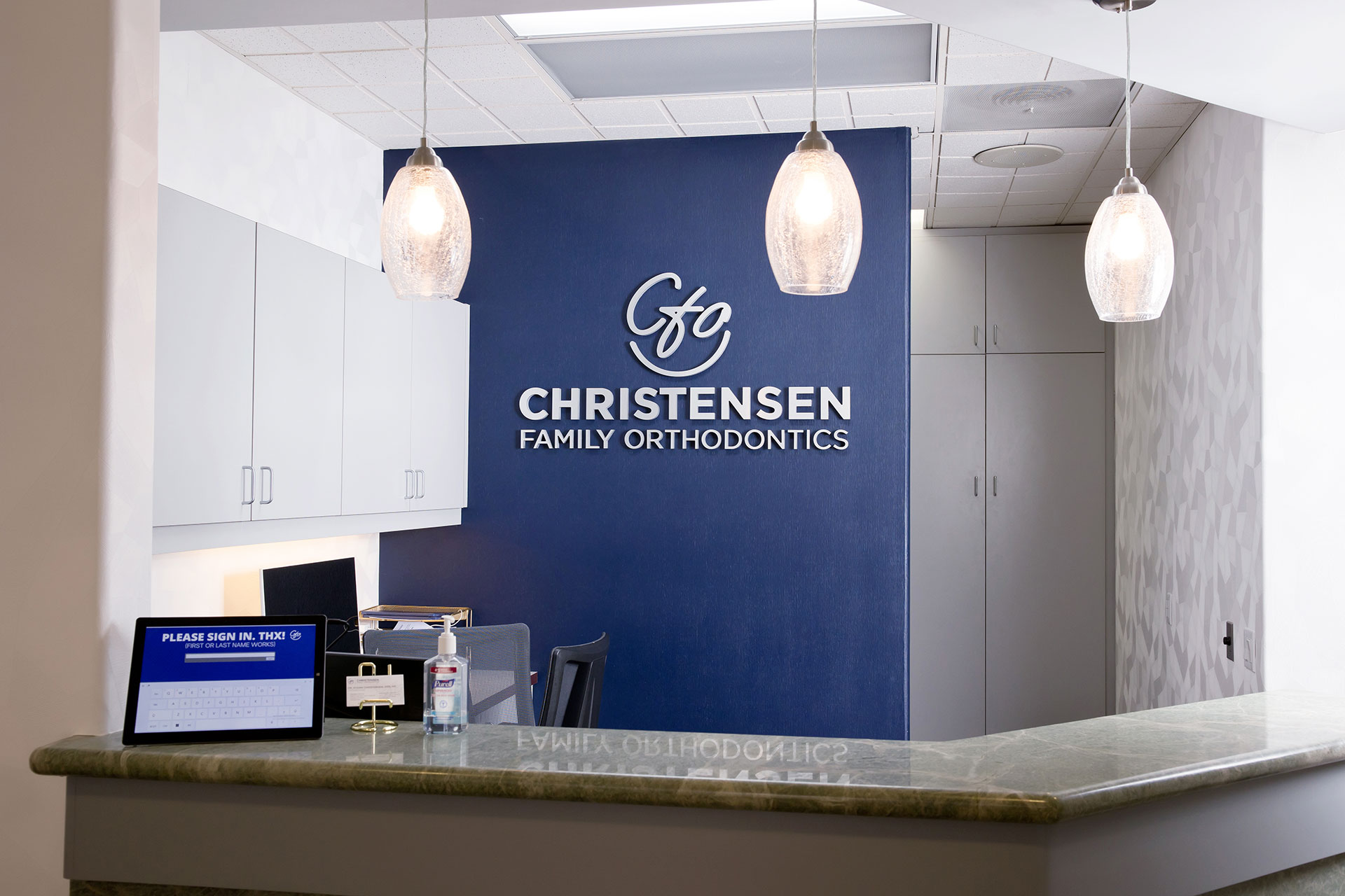 Reception Desk at Christensen Family Orthodontics Close-up of person showing how to Clean Braces